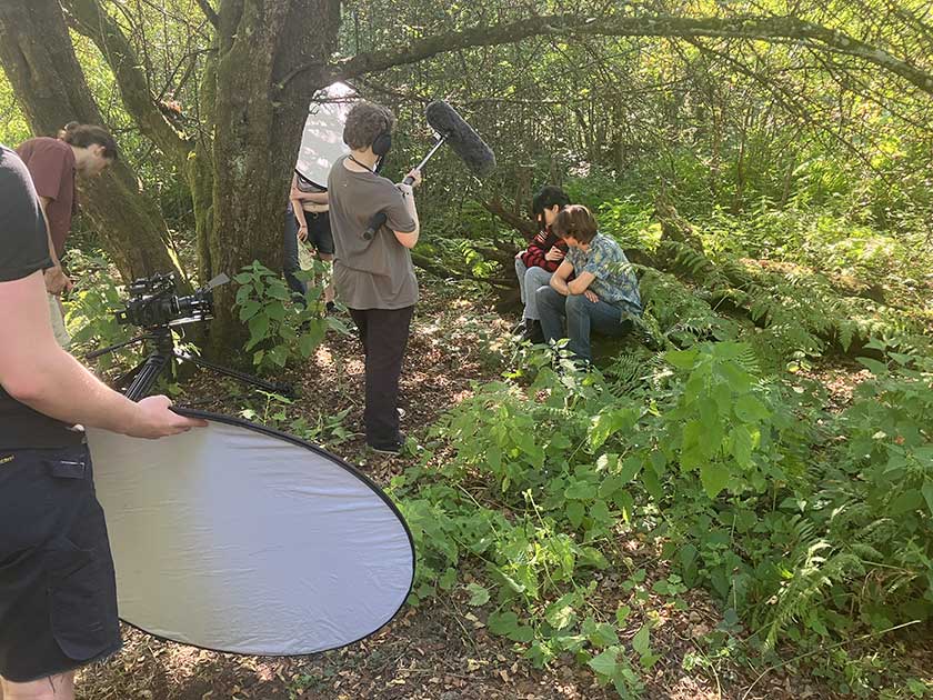 Filming on location in the woods, some welcome shade