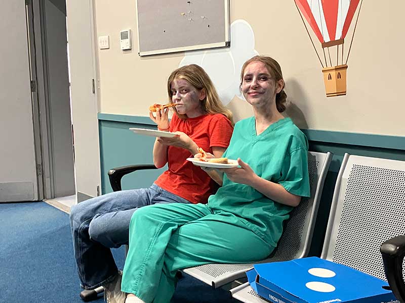 Zombie Lottie and Amber enjoying their pizza 