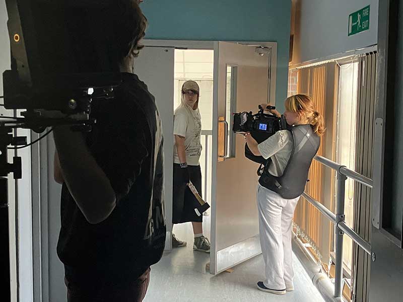 Noah on camera on location at the Hospital Studios